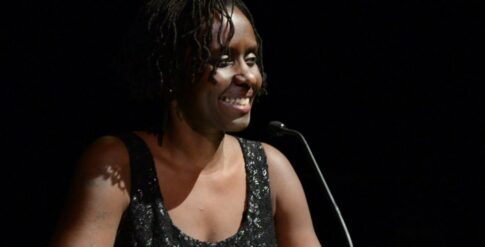 Juliane Okot Bitek onstage with a microphone